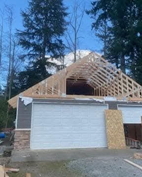 Detached garage under construction with roof trusses set