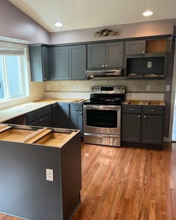 Kitchen remodel in progress — new gray shaker cabinets installed, countertops next